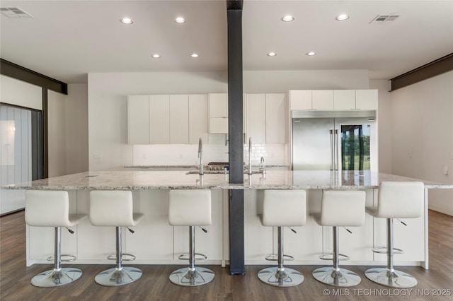 14382 Adams Rd, Mounds, OK 74047 - kitchen featuring stainless steel built in fridge, modern cabinets, recessed lighting, a large island with sink, and white cabinets