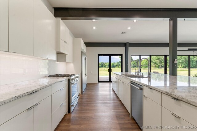 14382 Adams Rd, Mounds, OK 74047 - kitchen featuring stainless steel appliances, healthy amount of natural light, decorative backsplash, dark wood-style flooring, and recessed lighting