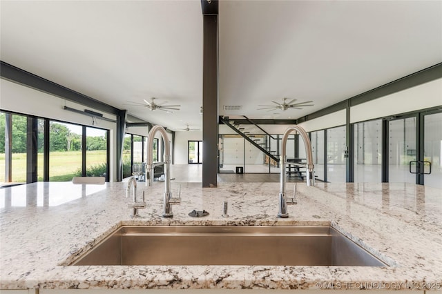 14382 Adams Rd, Mounds, OK 74047 - kitchen view of light stone countertops and a ceiling fan