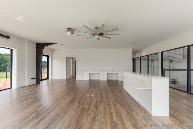 14382 Adams Rd, Mounds, OK 74047 - unfurnished living room with a ceiling fan and wood finished floors
