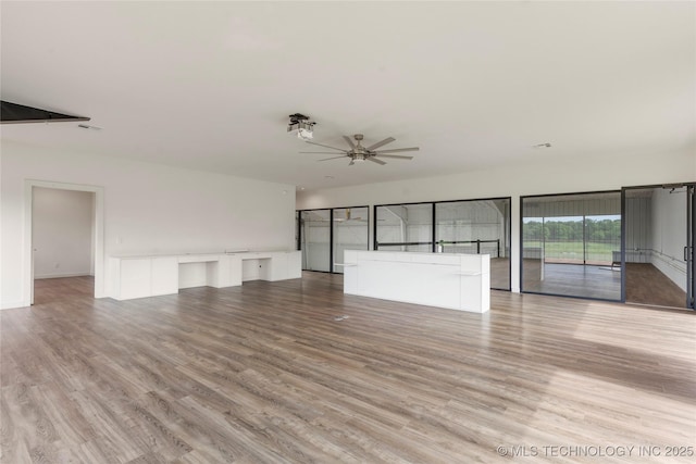 14382 Adams Rd, Mounds, OK 74047 - unfurnished living room featuring light wood-type flooring and a ceiling fan