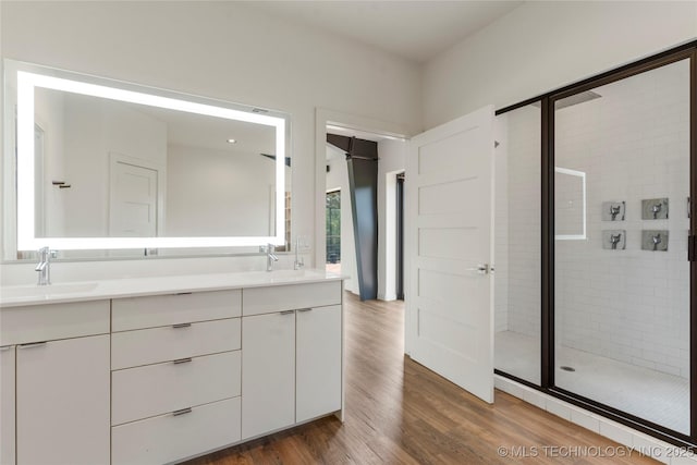 14382 Adams Rd, Mounds, OK 74047 - full bathroom with double vanity, a stall shower, and wood finished floors