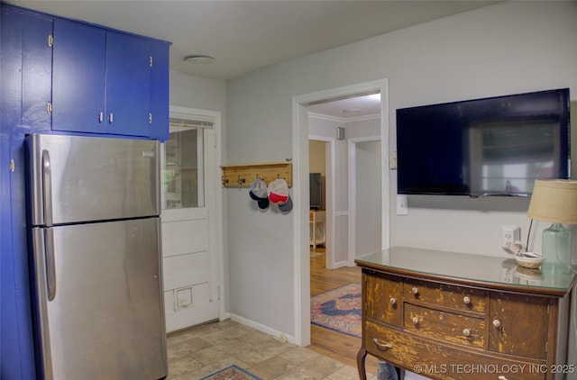 806 S New Haven Ave, Tulsa, OK 74112 - kitchen featuring freestanding refrigerator, blue cabinetry, and crown molding