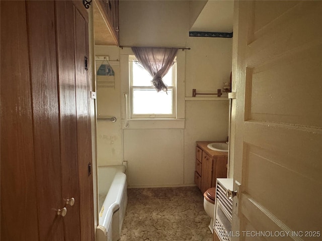 1524 W Maple St W, Durant, OK 74701 - bathroom with vanity, a tub to relax in, radiator, and toilet