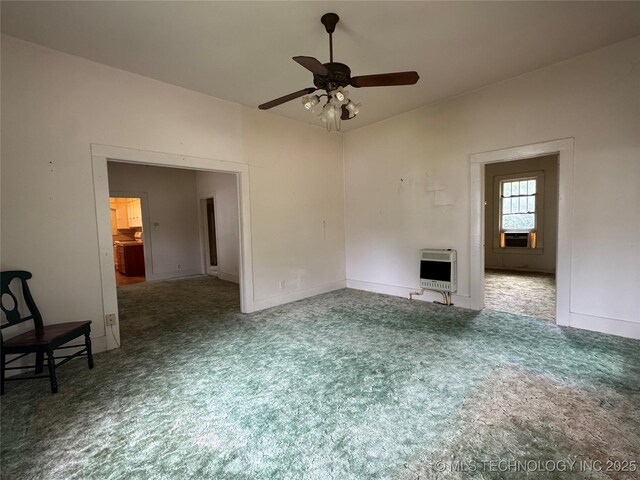 1524 W Maple St W, Durant, OK 74701 - unfurnished living room featuring heating unit, ceiling fan, carpet, and baseboards