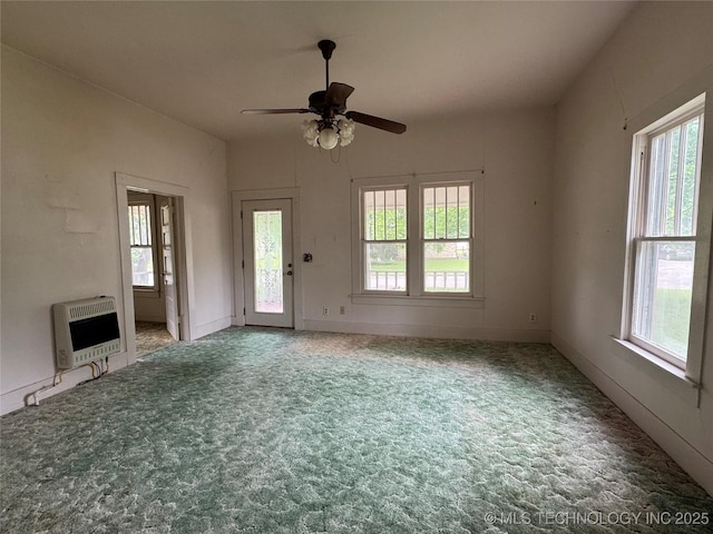 1524 W Maple St W, Durant, OK 74701 - unfurnished living room with heating unit, ceiling fan, and carpet floors