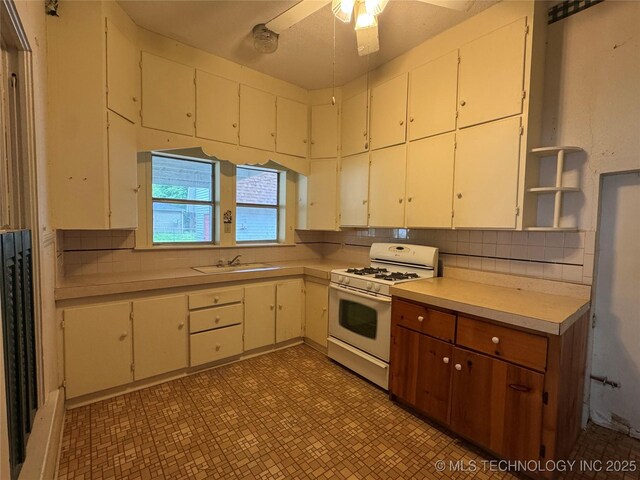 1524 W Maple St W, Durant, OK 74701 - kitchen with white range with gas stovetop, open shelves, light countertops, and light flooring