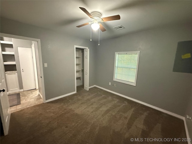 1618 Houston St, Muskogee, OK 74403 - unfurnished bedroom featuring carpet flooring, baseboards, ceiling fan, a closet, and a walk in closet