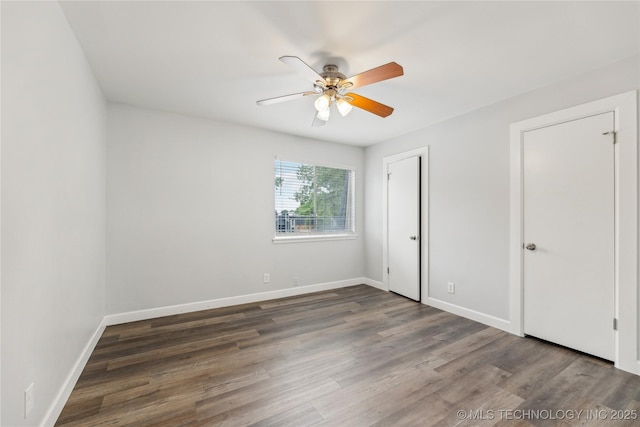 4440 68th St Unit 486, Tulsa, OK 74136 - unfurnished bedroom featuring wood finished floors, baseboards, and a ceiling fan