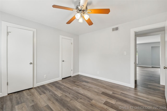 4440 68th St Unit 486, Tulsa, OK 74136 - unfurnished bedroom with wood finished floors, baseboards, and ceiling fan