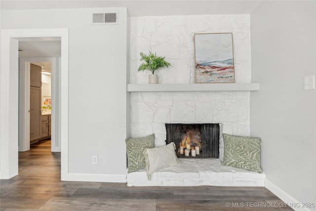 4440 68th St Unit 486, Tulsa, OK 74136 - detailed view of wood finished floors, baseboards, and a fireplace