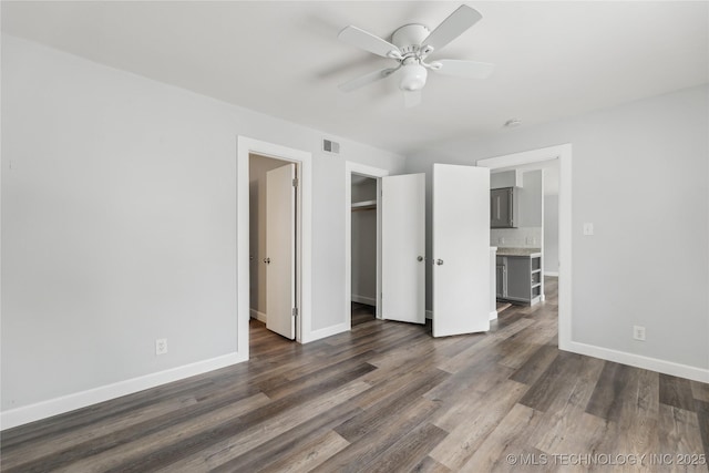 4440 68th St Unit 486, Tulsa, OK 74136 - unfurnished bedroom with dark wood-style flooring, baseboards, and ceiling fan