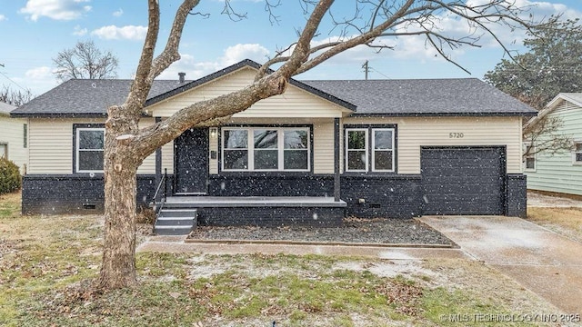 5720 E 21st St, Tulsa, OK 74114 - view of front of property featuring an attached garage, driveway, roof with shingles, and crawl space