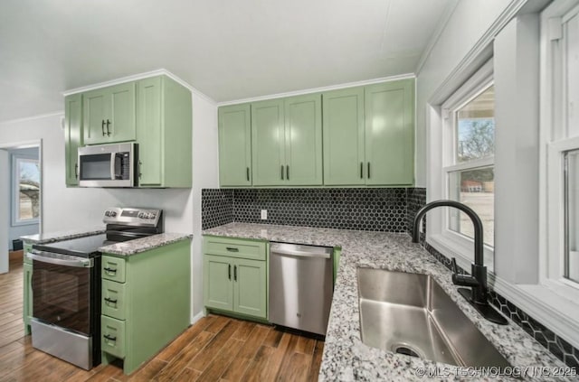 5720 E 21st St, Tulsa, OK 74114 - kitchen with green cabinets, stainless steel appliances, a sink, and ornamental molding