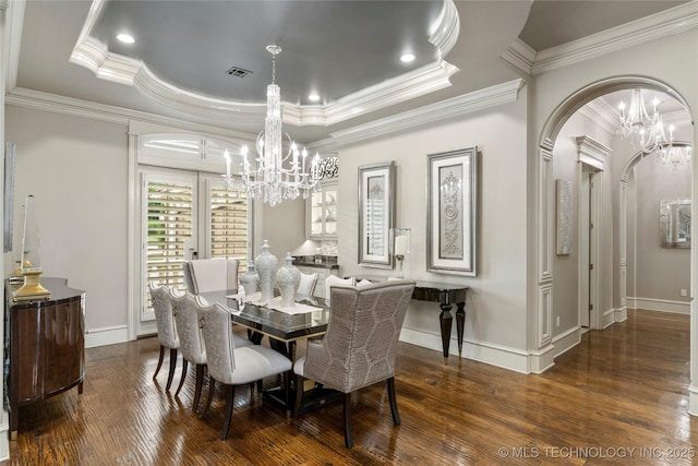 5879 N Eagle Summit Rd, Owasso, OK 74055 - dining area with a chandelier, dark wood finished floors, baseboards, crown molding, and a tray ceiling