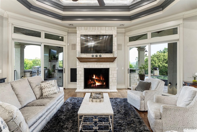 5879 N Eagle Summit Rd, Owasso, OK 74055 - living room featuring ornamental molding, a fireplace, plenty of natural light, wood finished floors, and a high ceiling