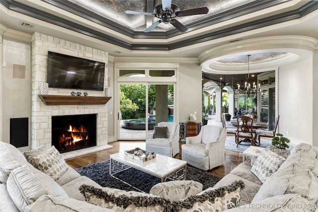 5879 N Eagle Summit Rd, Owasso, OK 74055 - living area featuring ornamental molding, wood finished floors, a ceiling fan, a fireplace, and a raised ceiling