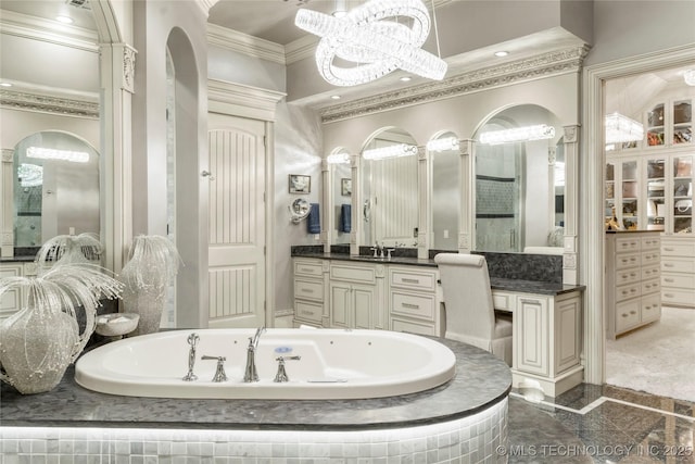 5879 N Eagle Summit Rd, Owasso, OK 74055 - bathroom with crown molding, granite tiled floors, a garden tub, vanity, and a chandelier