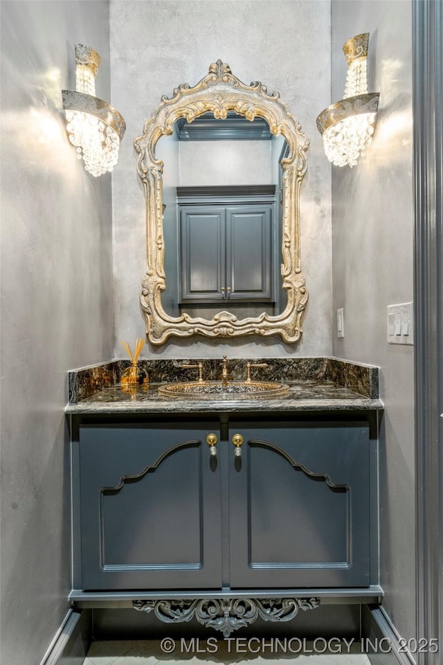 5879 N Eagle Summit Rd, Owasso, OK 74055 - bathroom with a chandelier, vanity, and baseboards