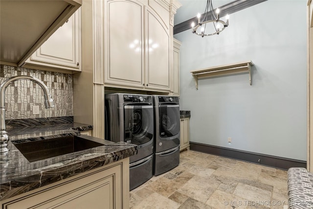 5879 N Eagle Summit Rd, Owasso, OK 74055 - washroom with cabinet space, separate washer and dryer, stone tile floors, baseboards, and a chandelier