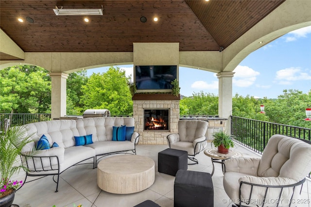 5879 N Eagle Summit Rd, Owasso, OK 74055 - view of patio / terrace featuring an outdoor living space with a fireplace