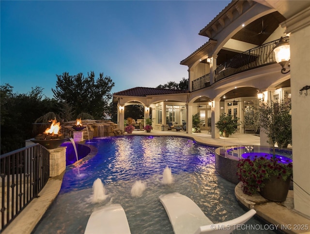 5879 N Eagle Summit Rd, Owasso, OK 74055 - view of swimming pool with a fire pit, a pool with connected hot tub, a patio area, french doors, and a ceiling fan