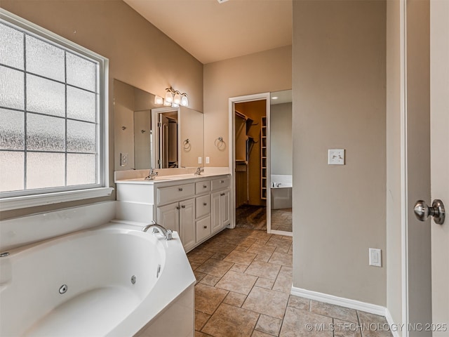 4610 E 142nd St S, Bixby, OK 74008 - full bath featuring double vanity, stone tile floors, a tub with jets, and a walk in closet