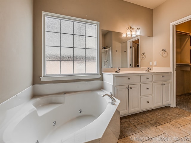 4610 E 142nd St S, Bixby, OK 74008 - full bathroom with double vanity, a whirlpool tub, and a walk in closet