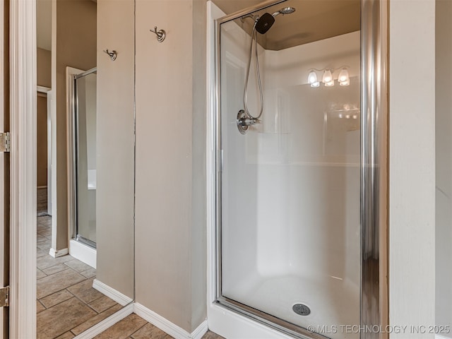 4610 E 142nd St S, Bixby, OK 74008 - bathroom featuring a shower stall and stone finish floors