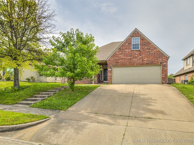 4610 E 142nd St S, Bixby, OK 74008 - view of front of property with brick siding, driveway, and a front lawn