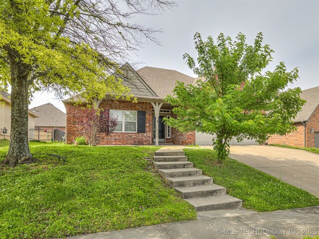4610 E 142nd St S, Bixby, OK 74008 - obstructed view of property with driveway, a garage, brick siding, and roof with shingles