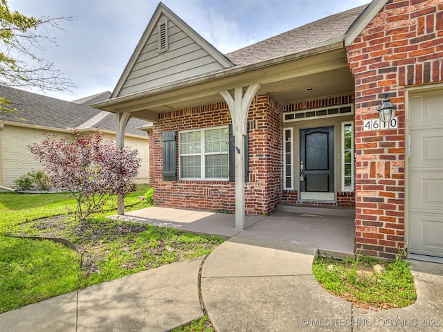 4610 E 142nd St S, Bixby, OK 74008 - property entrance featuring brick siding, covered porch, and roof with shingles