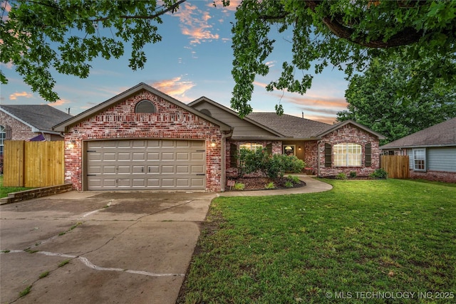 5202 Greenan Dr, Sand Springs, OK 74063 - ranch-style home featuring concrete driveway, an attached garage, brick siding, and a shingled roof
