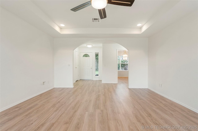 5202 Greenan Dr, Sand Springs, OK 74063 - unfurnished room with arched walkways, ceiling fan, a tray ceiling, light wood finished floors, and recessed lighting