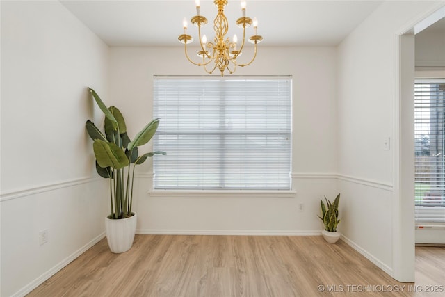 5202 Greenan Dr, Sand Springs, OK 74063 - empty room featuring a chandelier, wood finished floors, and baseboards