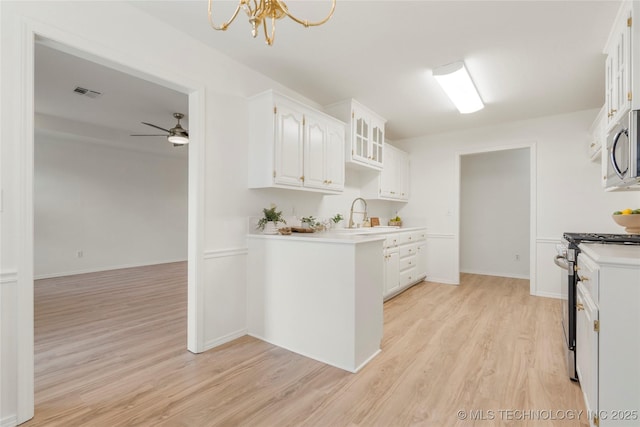 5202 Greenan Dr, Sand Springs, OK 74063 - kitchen with stainless steel appliances, light wood-style floors, white cabinetry, light countertops, and ceiling fan