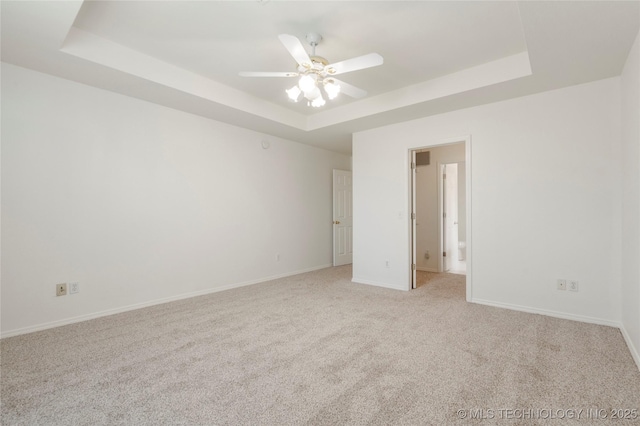 5202 Greenan Dr, Sand Springs, OK 74063 - empty room with a tray ceiling, light colored carpet, baseboards, and a ceiling fan