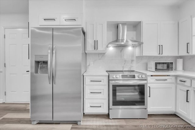 1008 E 54th St S, Tulsa, OK 74105 - kitchen featuring stainless steel appliances, wall chimney exhaust hood, crown molding, white cabinets, and light countertops