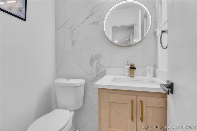 1008 E 54th St S, Tulsa, OK 74105 - bathroom featuring toilet, vanity, and tile walls