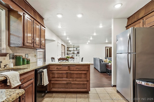 911 S Boyd Pl, Sapulpa, OK 74066 - kitchen with freestanding refrigerator, dishwasher, a peninsula, light tile patterned flooring, and recessed lighting