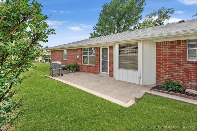 911 S Boyd Pl, Sapulpa, OK 74066 - back of property featuring a patio area, a lawn, brick siding, and roof with shingles
