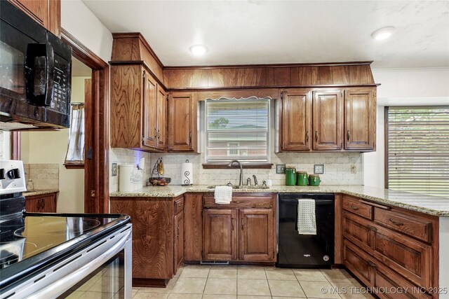 911 S Boyd Pl, Sapulpa, OK 74066 - kitchen featuring black appliances, a sink, decorative backsplash, light stone countertops, and light tile patterned flooring
