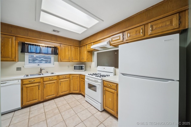 9703 N 109th E Ave, Owasso, OK 74055 - kitchen with white appliances, under cabinet range hood, a sink, light tile patterned floors, and light countertops