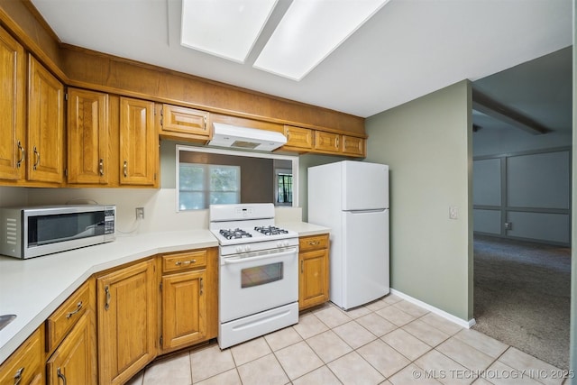 9703 N 109th E Ave, Owasso, OK 74055 - kitchen with white appliances, light countertops, under cabinet range hood, and light tile patterned flooring