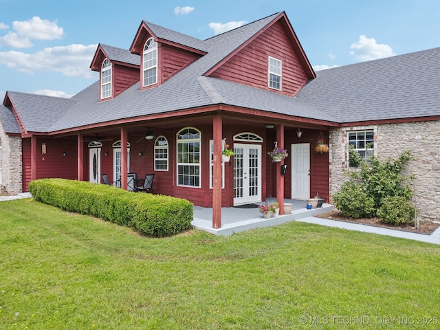 5757 W 181st St S, Mounds, OK 74047 - view of front of house featuring french doors, stone siding, a front yard, roof with shingles, and covered porch