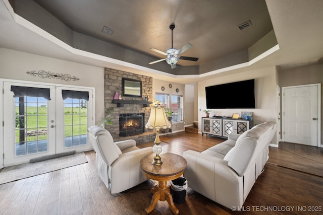 5757 W 181st St S, Mounds, OK 74047 - living room featuring a raised ceiling, hardwood / wood-style floors, a ceiling fan, a fireplace, and french doors