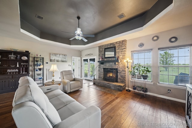5757 W 181st St S, Mounds, OK 74047 - living area with a tray ceiling, a stone fireplace, hardwood / wood-style floors, and a ceiling fan