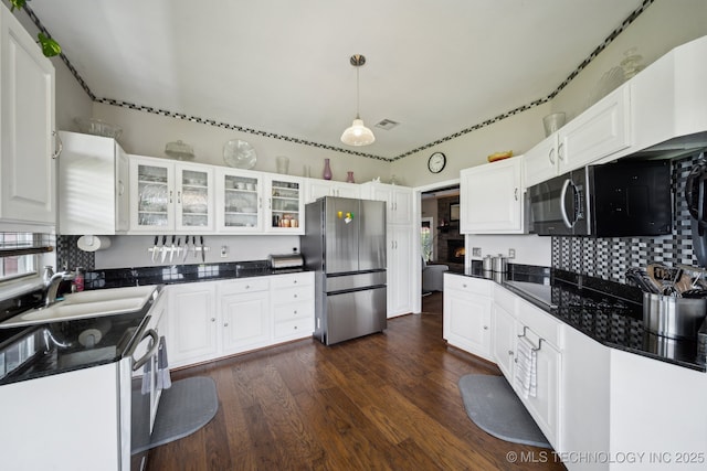 5757 W 181st St S, Mounds, OK 74047 - kitchen featuring freestanding refrigerator, black microwave, dark countertops, white cabinets, and dark wood finished floors