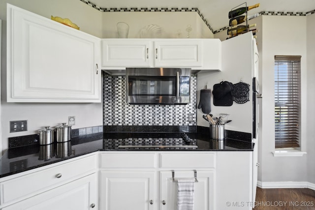 5757 W 181st St S, Mounds, OK 74047 - kitchen featuring stainless steel microwave, black electric cooktop, white cabinetry, and dark wood-style floors