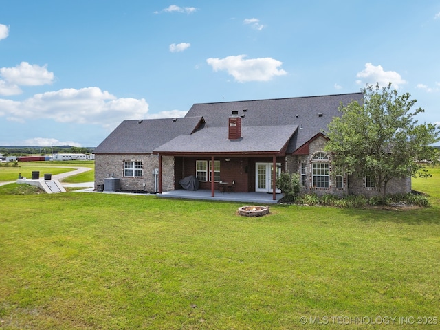 5757 W 181st St S, Mounds, OK 74047 - rear view of house with an outdoor fire pit, a patio area, a lawn, a chimney, and roof with shingles